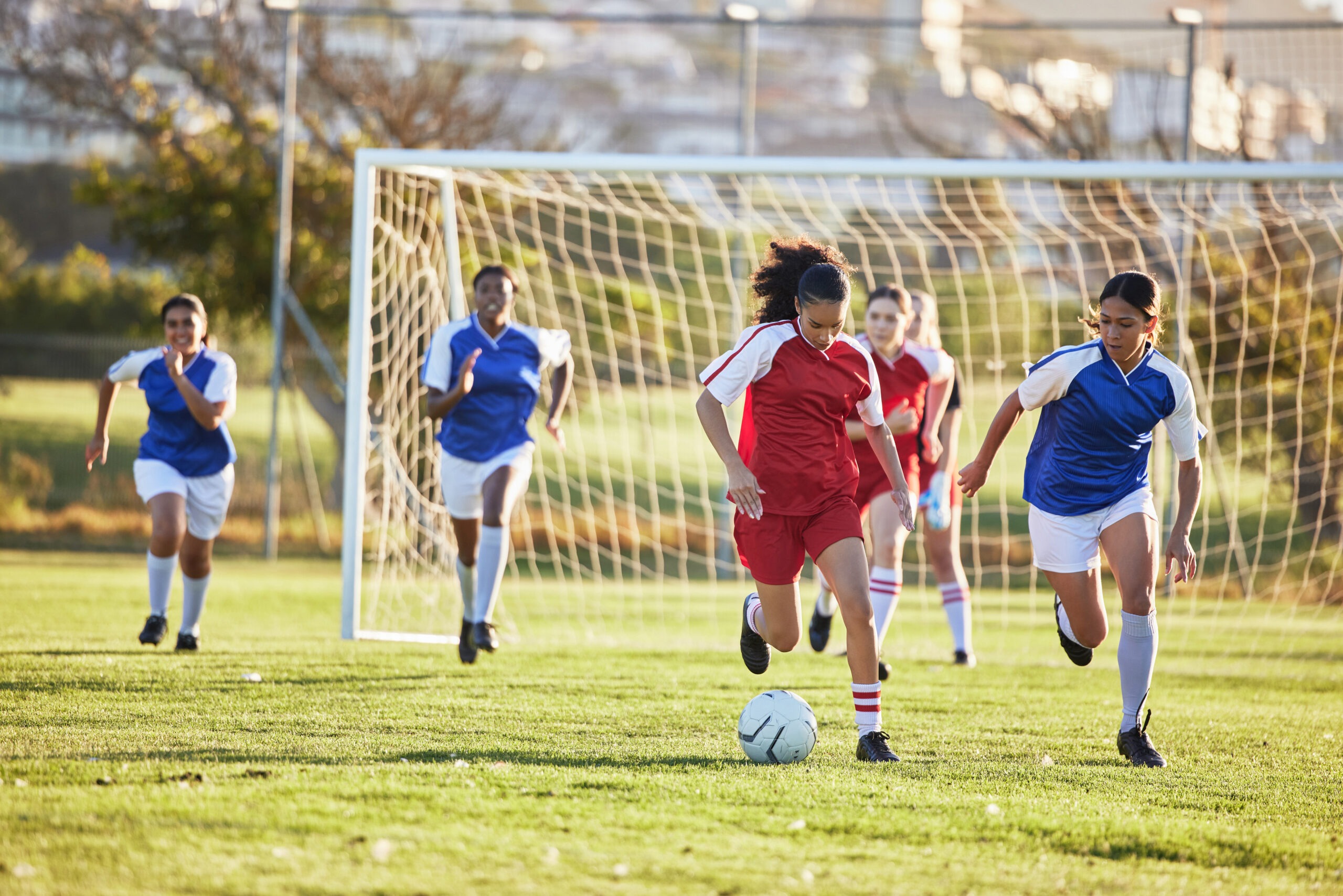 Girls playing soccer using a mouthguard. 